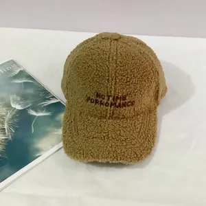 Close-up of brown faux shearling baseball cap with NO TIME FOR ROMANCE embroidery