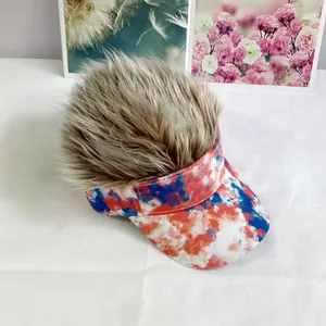 Macro shot of brown synthetic wig hair attached to red blue and white tie-dye visor cap