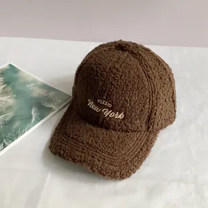 Close-up of brown sherpa fleece baseball cap with New York embroidery for winter