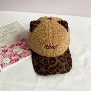 Detail of plush cat ear baseball cap with leopard print accents and new embroidery