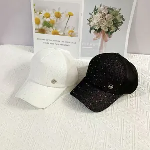 Breathable lace baseball cap with sequins and metallic MC logo in black and white
