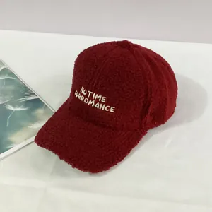 Close-up of NO TIME FOR ROMANCE embroidery on burgundy fleece baseball cap