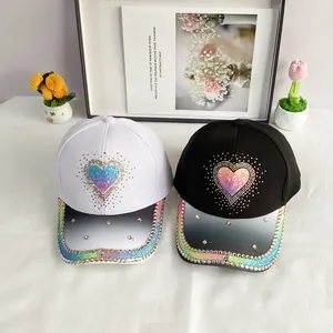 Black and white baseball caps with colorful rhinestone hearts and gradient glitter finish