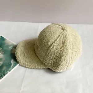 Detailed texture of cream fleece baseball cap with warm wool-like fabric for winter