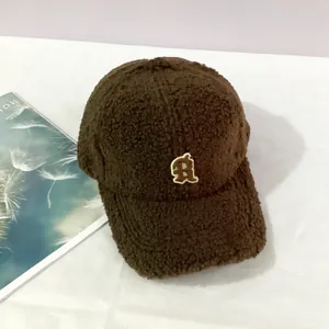 Close-up of thick coffee brown teddy fleece baseball cap with white R letter embroidery