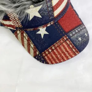 Detail of baseball cap with American flag pattern and grey faux hair wig on the top