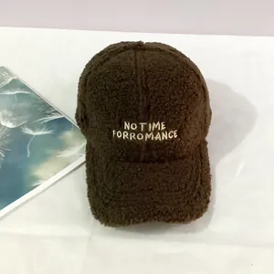 Detail of brown faux shearling baseball cap with NO TIME FOR ROMANCE embroidery