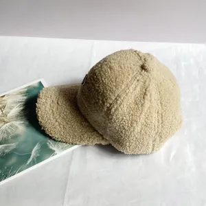 Texture dettagliata della spessa lana d'agnello beige su un berretto da baseball invernale