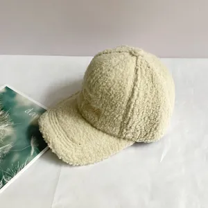 Close-up of off-white sherpa baseball cap with New York embroidery on textured background