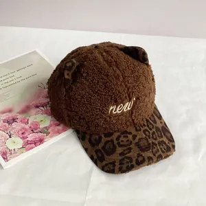 Detail of plush brown baseball cap with cat ears, leopard brim and new embroidery