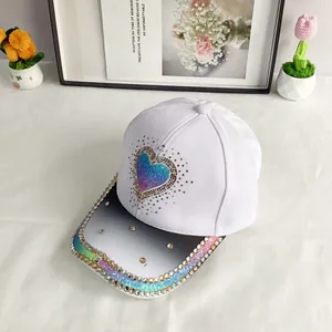Detail of baseball cap with gradient heart glitter and rainbow rhinestone brim decor