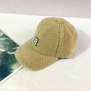 Close-up of khaki lamb wool baseball cap with white letter P embroidery on white background