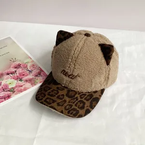 Close-up of winter cat ear baseball cap with leopard print accents and new embroidery