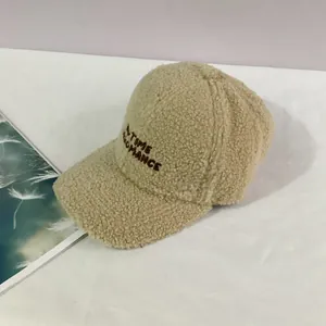 Detailed view of beige lamb wool baseball cap with TIME ROMANCE embroidery texture