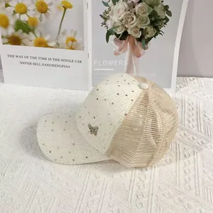 Close-up of cream mesh baseball cap with sequin fabric and metal butterfly buckle