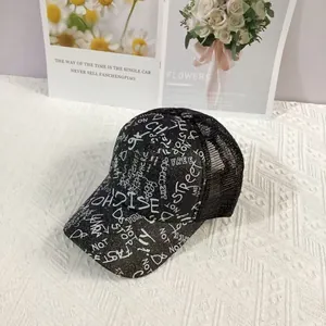 Detail of glitter baseball cap with graffiti letters and breathable black mesh back