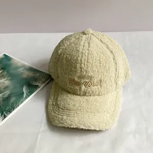Detail of New York embroidery on beige lamb wool baseball cap for winter warmth