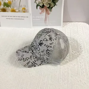 Detailed view of silver glitter baseball cap with black graffiti and breathable mesh