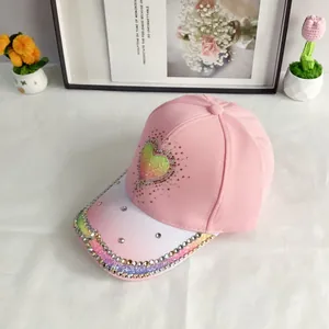 Detail of pink gradient baseball cap with rhinestone heart and studded brim
