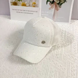 Close-up of white lace baseball cap with sequins and breathable mesh back detail