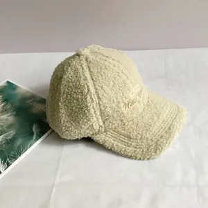 Close-up of the New York embroidery on a beige sherpa fleece winter baseball cap