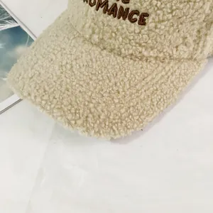 Close-up of ROMANCE embroidery on warm sherpa fleece baseball cap with soft texture