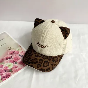 Detail of cute cat ears on plush sherpa baseball cap with brown leopard print accents