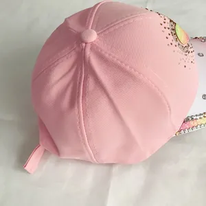 Detail of pink cotton baseball cap with colorful rhinestones and glitter patches