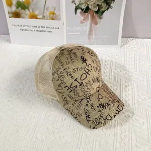 Close-up of glitter gold baseball cap with graffiti text and breathable mesh back