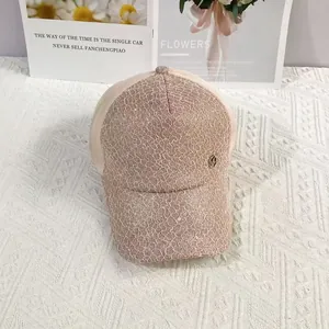 Close-up of pink lace baseball cap featuring delicate sequins and a metallic logo accent