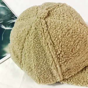Close-up of khaki lamb wool baseball cap texture with soft fleece and stitching details