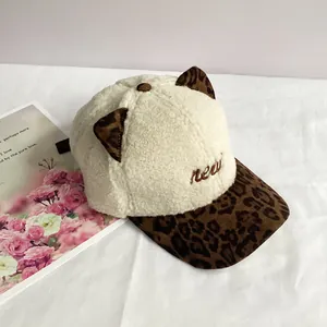 Detail of plush cat ears and leopard print brim on a warm sherpa baseball cap