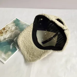 Close-up of soft beige sherpa baseball cap showing plush texture and inner lining