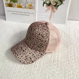 Close-up of pink glitter baseball cap with black letter print and breathable mesh back