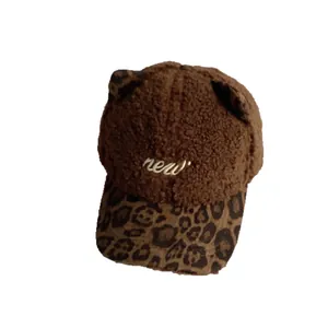 Brown fuzzy baseball cap with cat ears, leopard brim and white 'new' embroidery