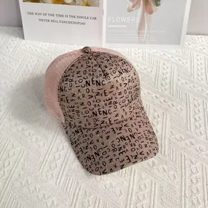 Detail of pink glitter baseball cap featuring black graffiti letters and breathable mesh