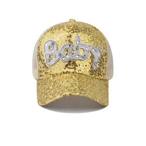 Detailed view of the Baby pearl lettering and sparkly gold sequins on the mesh baseball cap