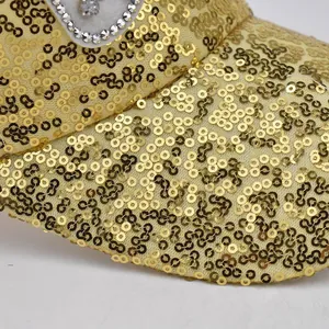 Detail of golden sequins and silver rhinestone patterns on breathable mesh cap fabric