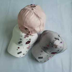 Glittery baseball caps with LOVE sequins and rhinestones in pink, white, and grey colors
