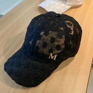 Women's black floral lace baseball cap with a rhinestone M logo and breathable mesh