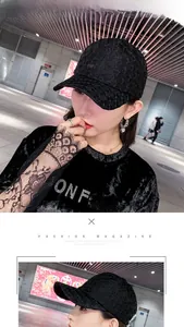 Detail view of a black lace baseball cap featuring hollow texture and floral pattern