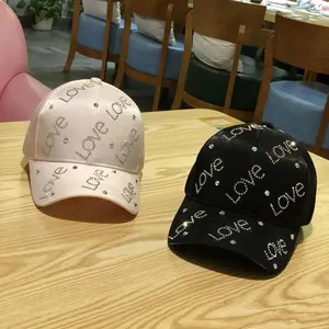 Women's baseball caps with rhinestone Love pattern in pink and black colors