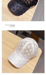 Detail of floral lace baseball caps in black and white with breathable mesh design