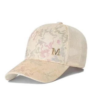 Detailed macro of camouflage mesh baseball cap featuring rhinestone M letter decoration