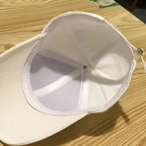 Detail view of the white baseball cap interior showing reinforced seams and cotton sweatband