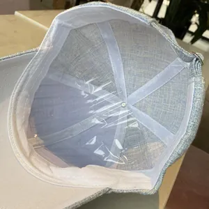 Detail view of light blue tweed baseball cap interior with white sweatband and stitching