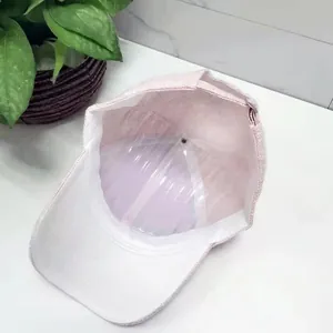 Detail view showing pink baseball cap interior with white brim and plastic shape holder
