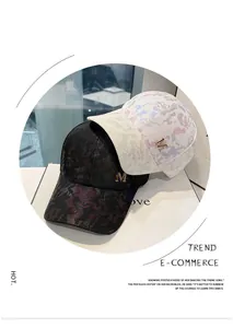 Detail of trendy camouflage baseball cap with gold metallic M logo and mesh fabric texture