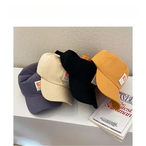 Detail view of cotton baseball caps with original legend patch in multiple colors