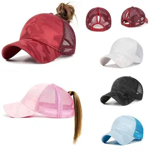 Detail of ponytail hole design on camouflage mesh baseball caps in multiple colors